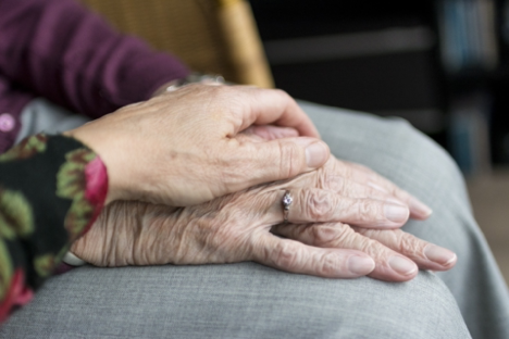 Holding an elderly person's hands. Does my loved on need help at home?