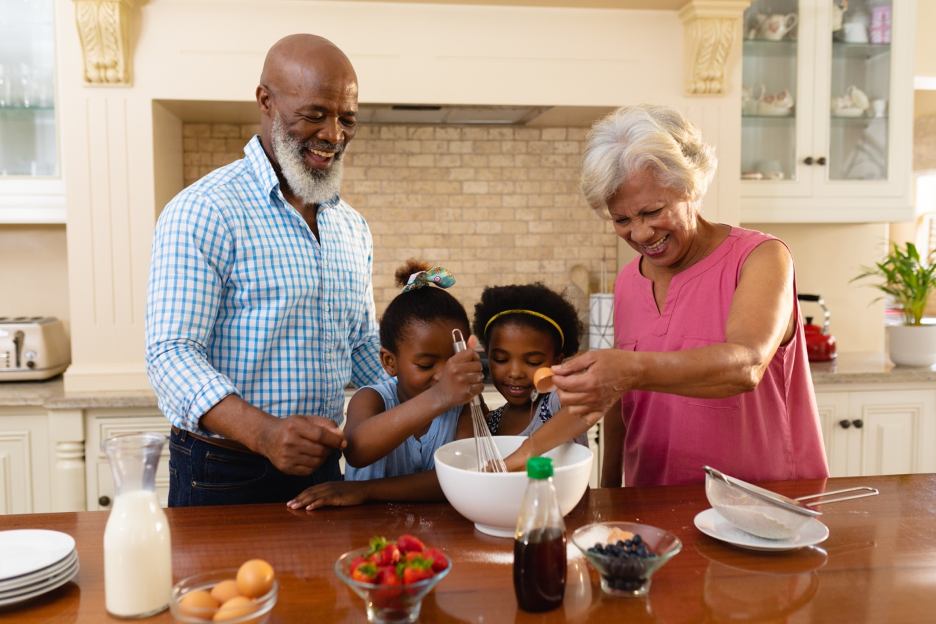 Grandparents baking with their grandchildren.